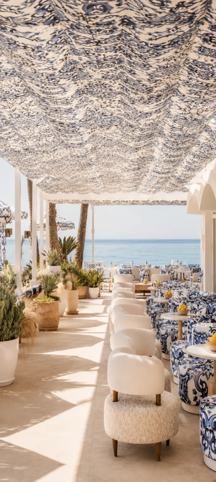 La Cabane Marbella terrace seating with blue-and-white textiles overlooking the sea