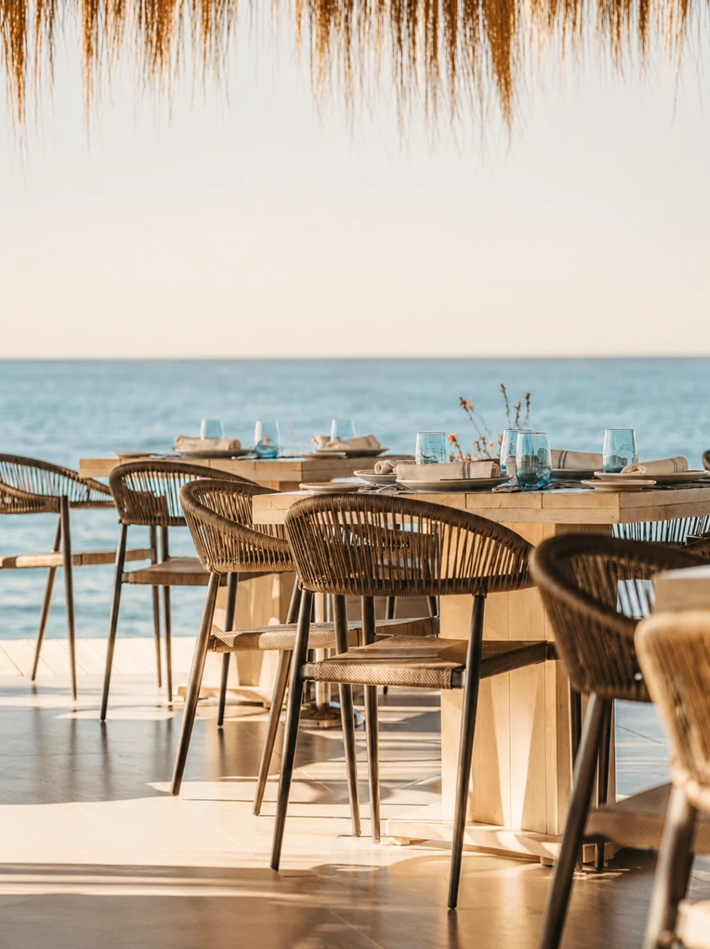La Milla Marbella dining terrace with woven lighting, sea views and natural timber finishes