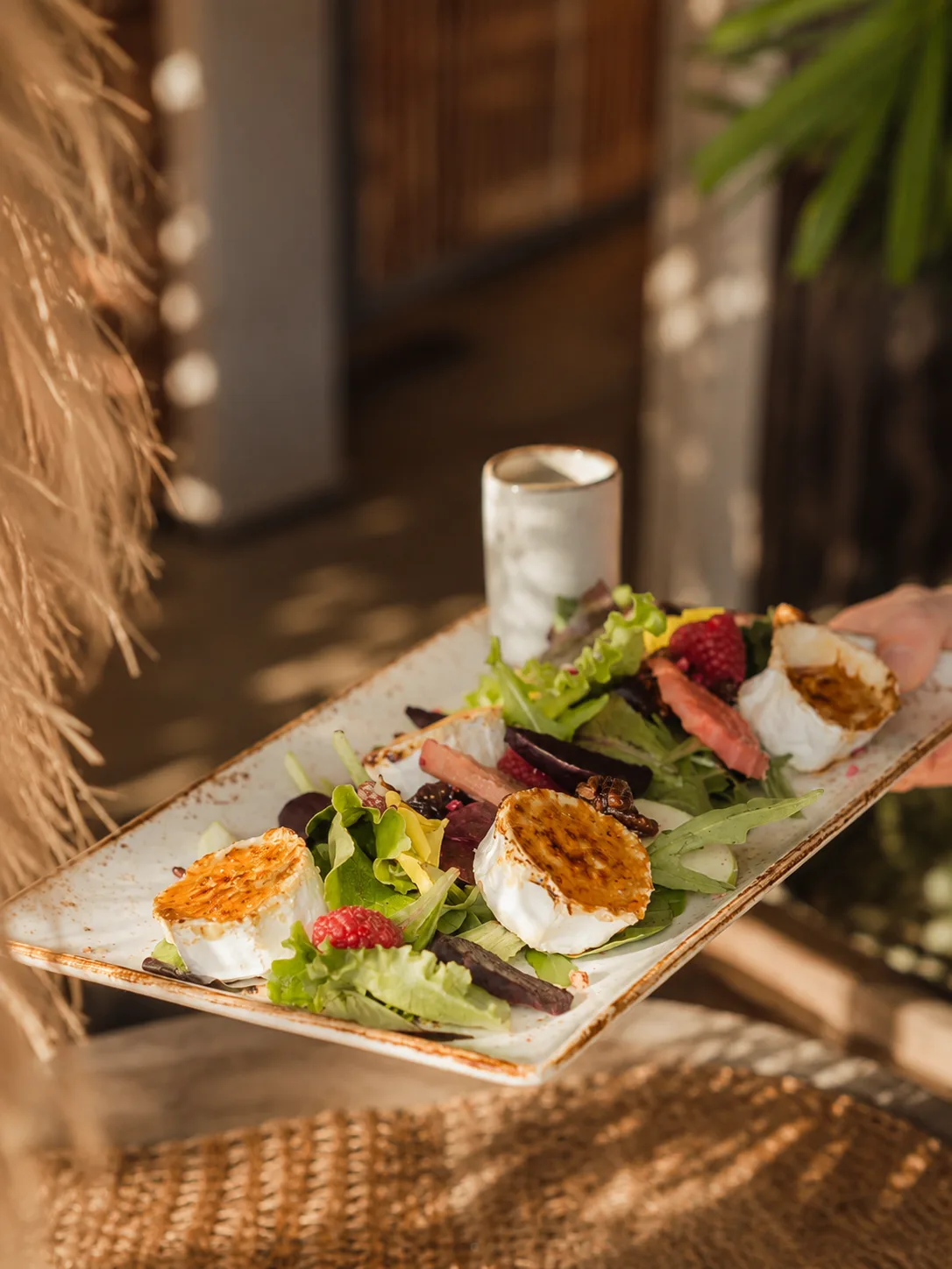 Fresh plated salad served at Luuma Beach Marbella in golden light